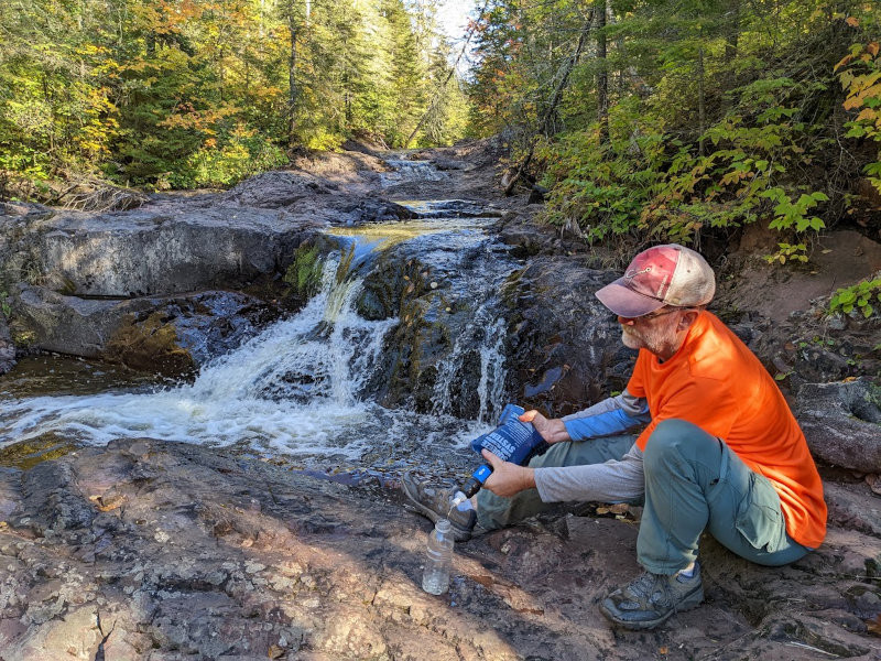 Sawyer Squeeze getting water on Kadunce River